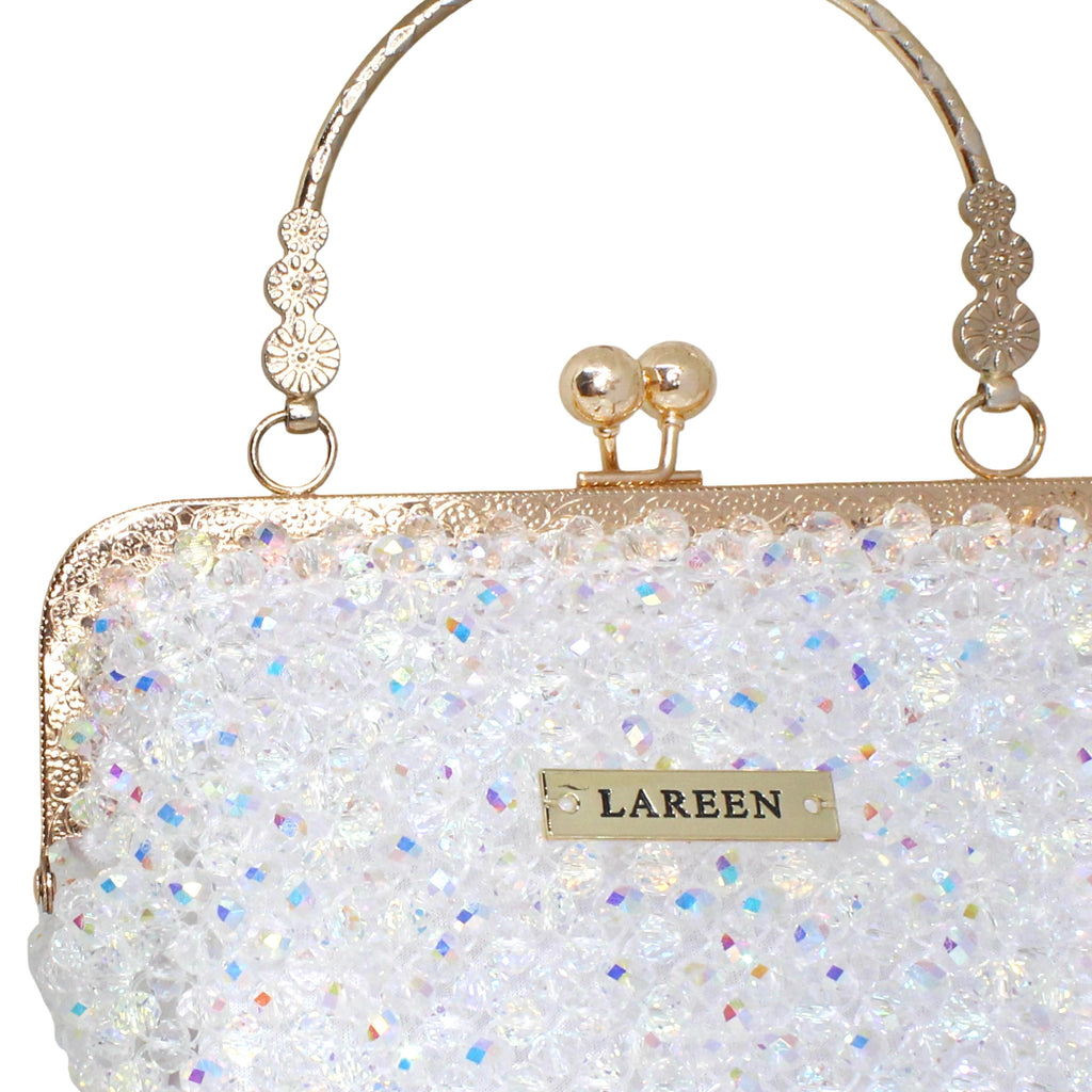 Close-up of crystal beadwork and gold details on Aurélia Crystal