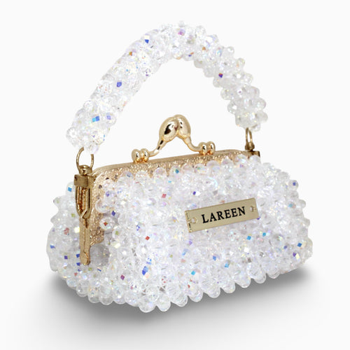 Aurélia Crystal Mini crystal beaded mini bag with gold handle, angled view